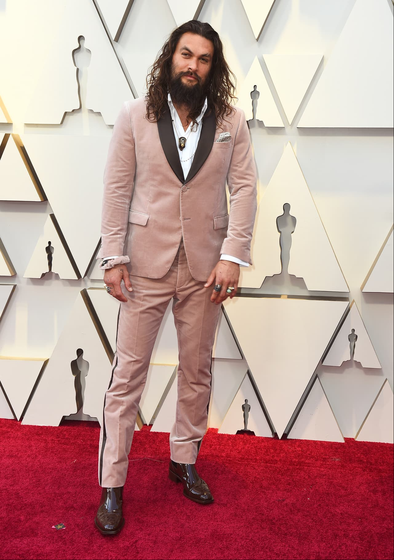 El actor Jason Momoa rompió los estándares y llegó con un traje de terciopelo y su característica melena.