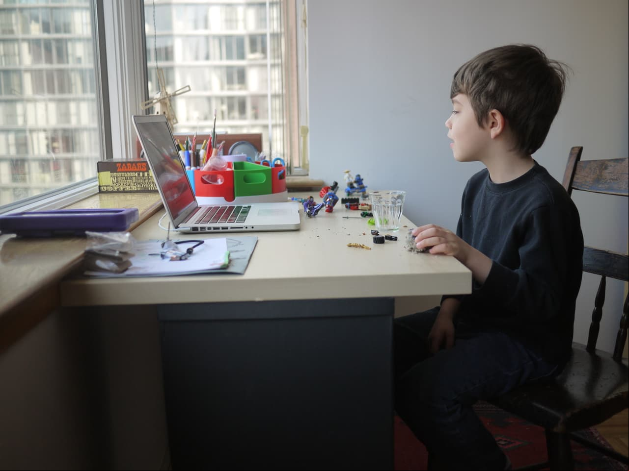 A young boy participates in an online lesson for his kindergarten class while schools remain closed to help slow the spread of COVID-19, Chicago, Illinois, April 3, 2020. (Photo by Interim Archives/Getty Images)