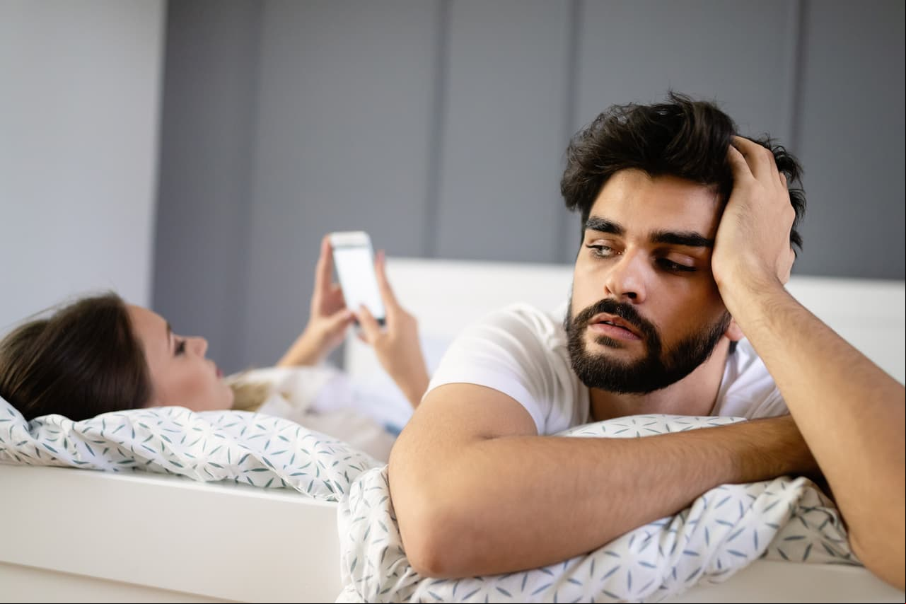 Couple problems. Husband is frustrated upset and unsatisfied while his internet addict wife is using mobile phone in social network